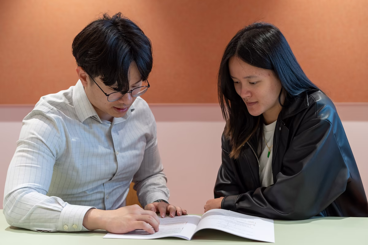 Our founder Vincent Tran teaching another student from our theory booklets.